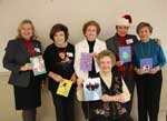 Displaying the Christmas cards made for them by students of Magnolia School is the Philanthropic Committee of 2011, Rubye Noble Evans, Anita Garcia, Agnes Jones, Cindy Enright and Verne di Cristina.  Seated is Sydney Condon.  The committee also held a party at the Hilda Knoff School for the Deaf as well as Magnolia School