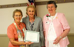 Joan Donnow is presented a certificate upon the celebration of her 25 years of membership in Metairie Woman's Club.  On left is June Prados, membership chairman, and on right is Sue Rooney, president of the club.