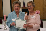 Sydney Condon receives a certificate for 25 years membership from June Prados