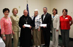 Linda Sharp, Coleen Landry, Abbot Justin Brown of St. Joseph's Abbey, President Linda Deichmann, Luis Arocha of Cafe' Hope, Carolyn Chassee of East Jefferson Hospital Foundation and Fran Puig