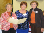 New member-Suzi Clemmensen is welcomed to the Club by June Prados, membership chairman, on left, and Jane Livaudais, sponsor, on right